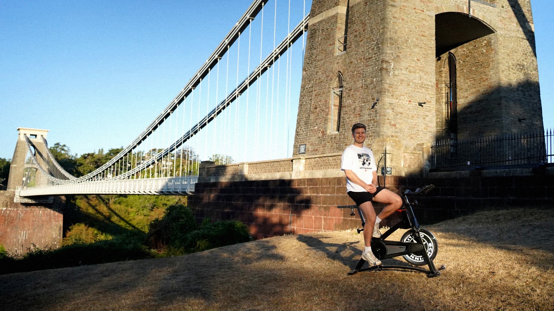 Haydn on a PACE bike in front of the Clifton Suspension Bridge at golden hour